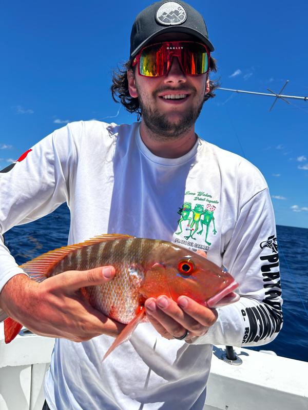 Fisherman showing a snapper after deep sea trip